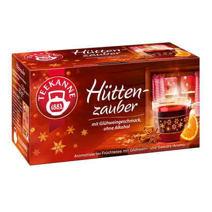 Freigestellte Teepackung „Teekanne Hüttenzauber“ im rot-goldenen Winterdesign mit Glühweintasse und Orangenstück.