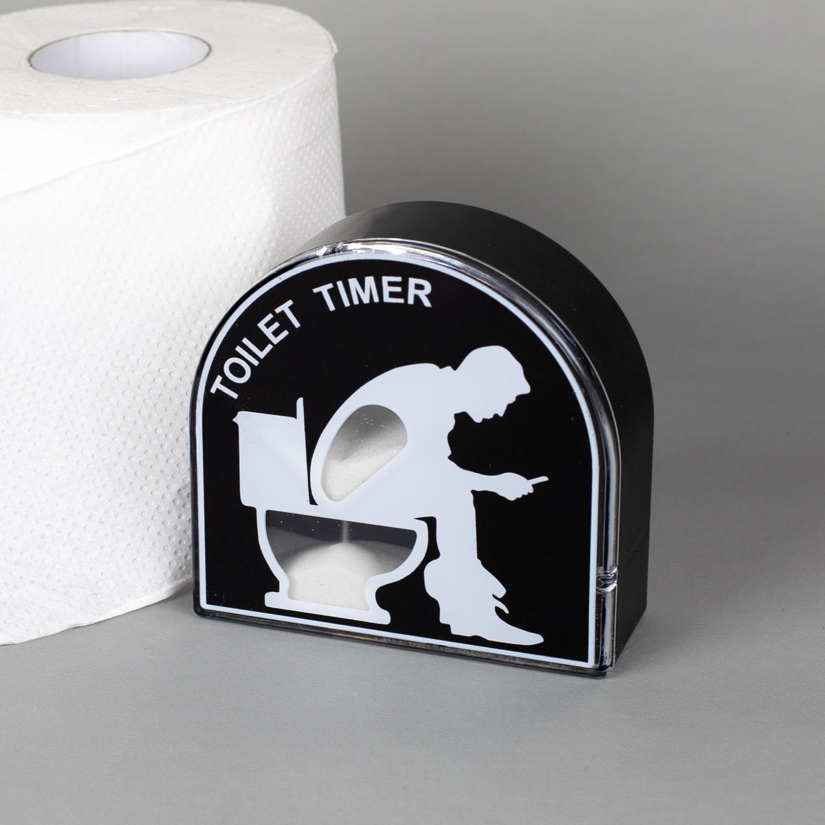 Lustiger Toilet Timer als Sanduhr mit schwarzem Design neben einer Toilettenpapierrolle