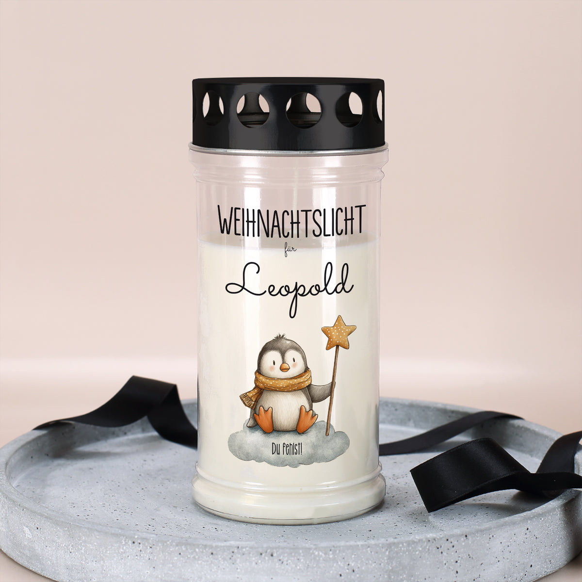 Personalisierte Weihnachts-Grabkerze mit Pinguinmotiv und Name Leopold, dekorativ auf Tablett arrangiert