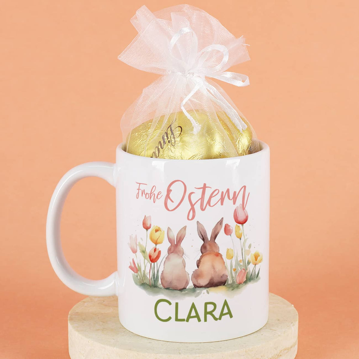 Frohe Ostern - Tasse mit Hasen, Blumen, Name - gefüllt mit Lindt Schokoladenherzen