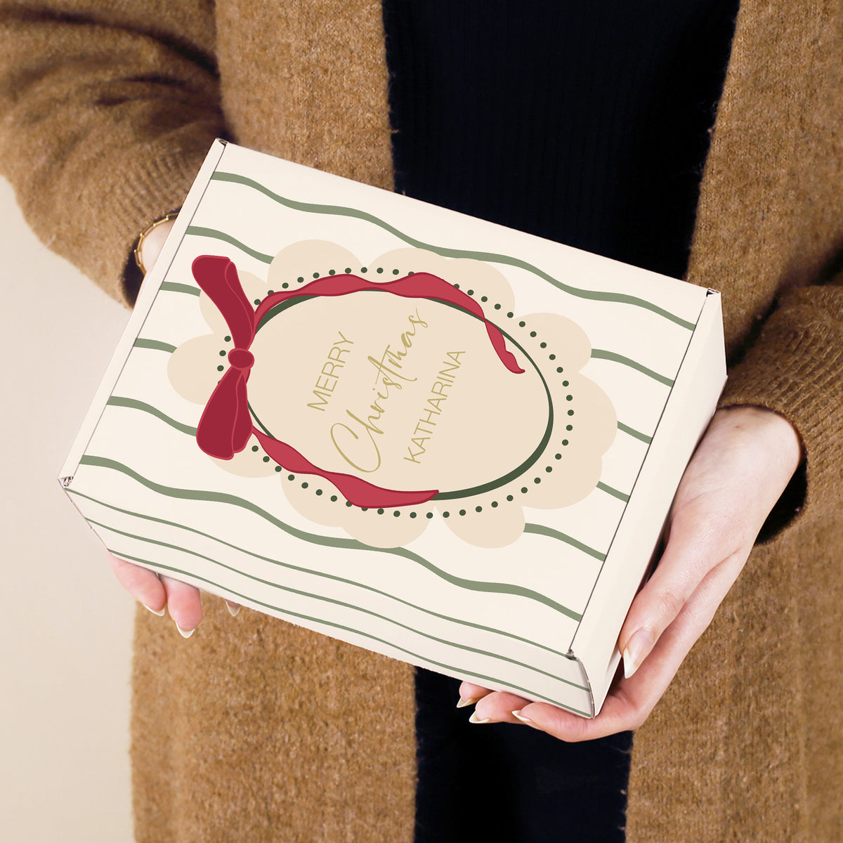 Festlich gestaltete Geschenkbox mit Weihnachtsdesign und personalisiertem Namen „Katharina“ in Händen gehalten