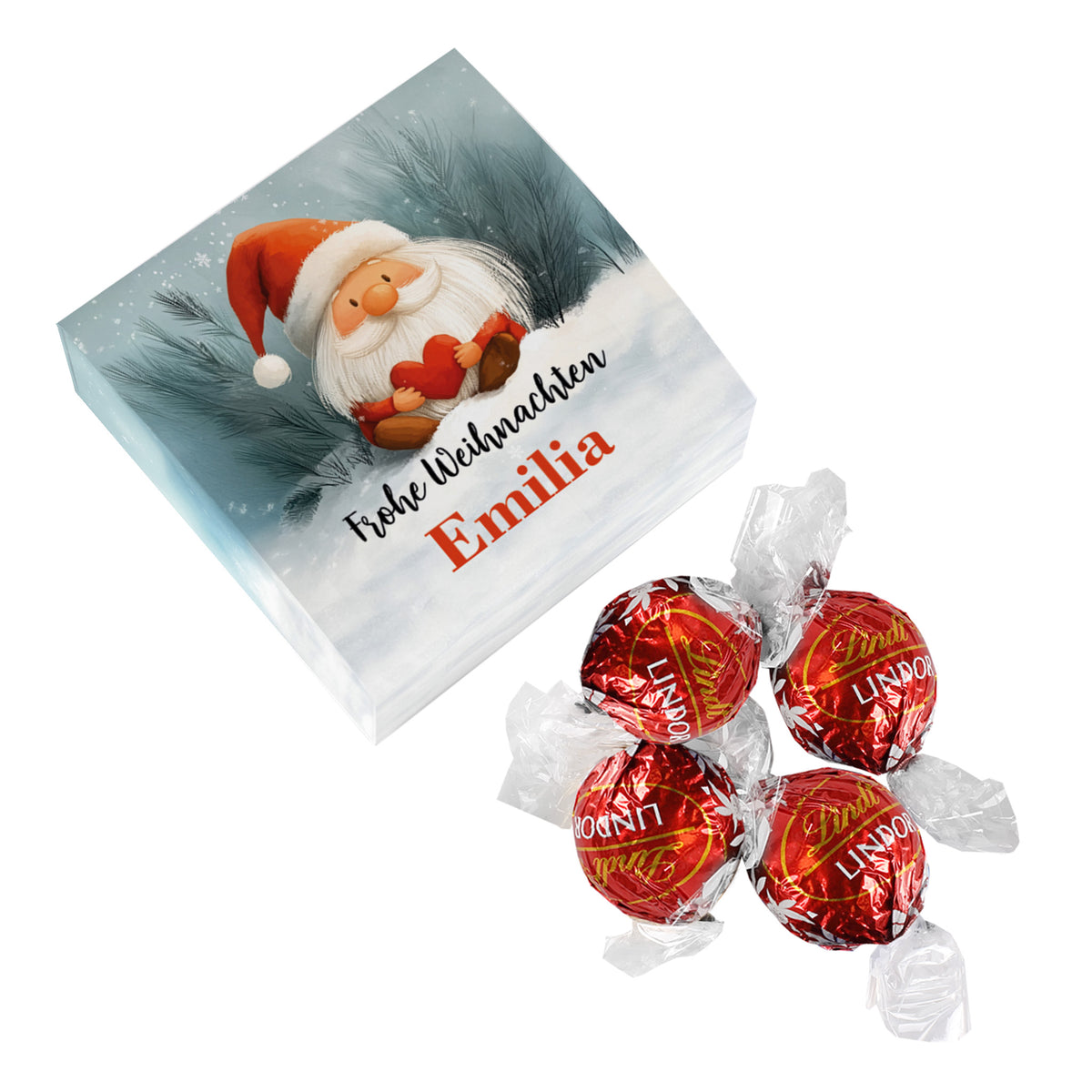 Geschenkbox mit Wichtel-Motiv und personalisiertem Text „Frohe Weihnachten – Emilia“, daneben vier Lindor-Kugeln in roter Folie